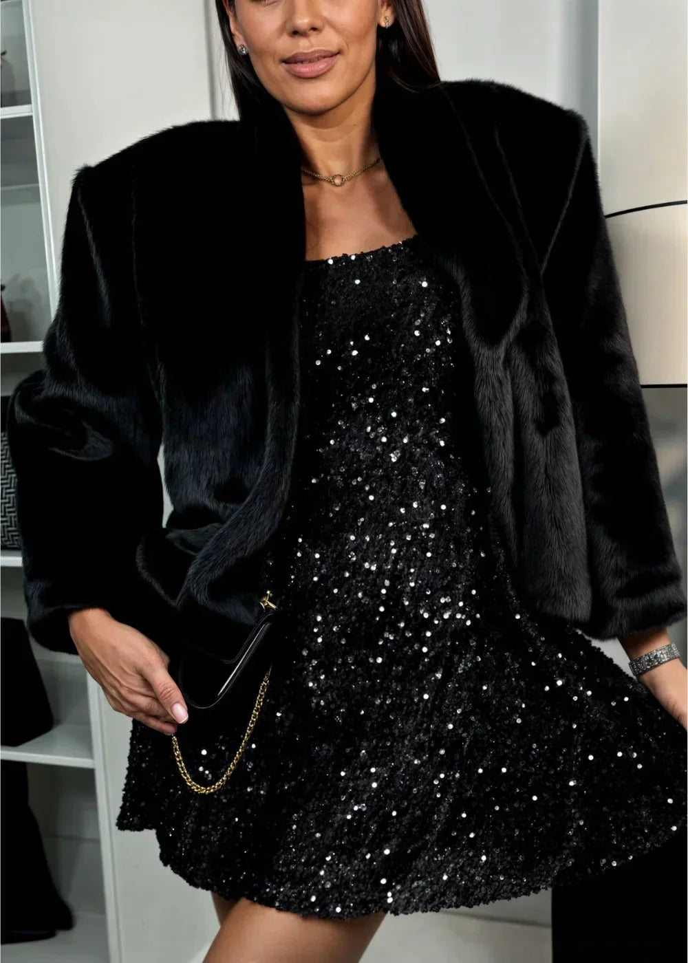 Women's black sequined mini dress with sweetheart neckline and long sleeves