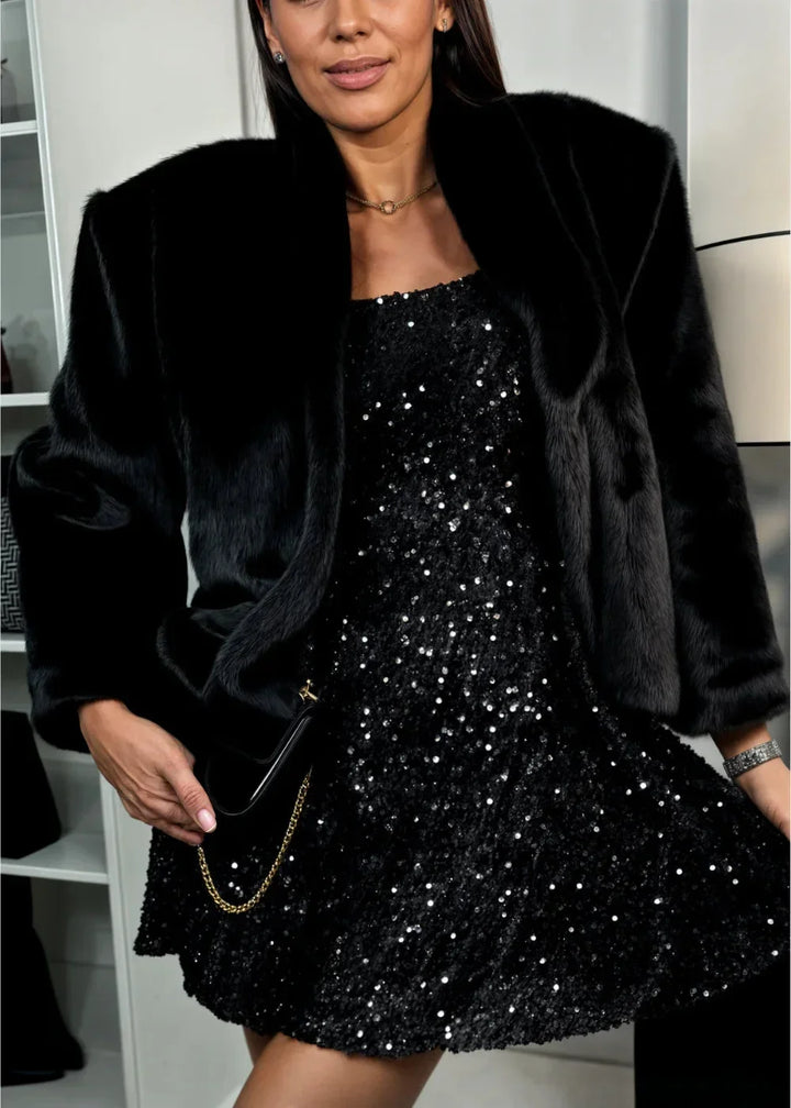 Women's black sequined mini dress with sweetheart neckline and long sleeves