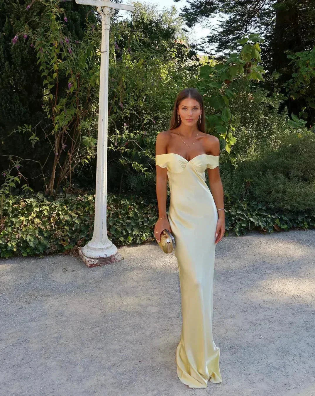 Women's off-shoulder yellow maxi dress with matching clutch