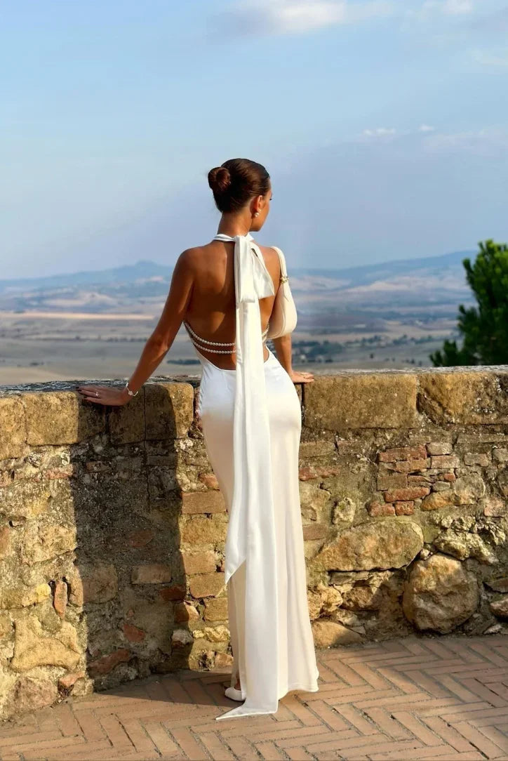 Women's white backless maxi dress with pearl accents and bow